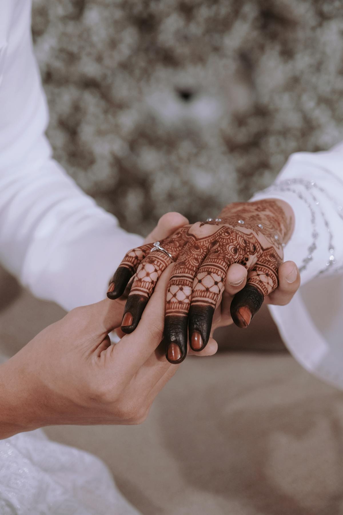 Bride and groom hands with wedding henna