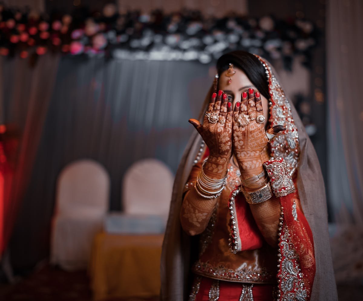 Bridal hands with red outfit and henna